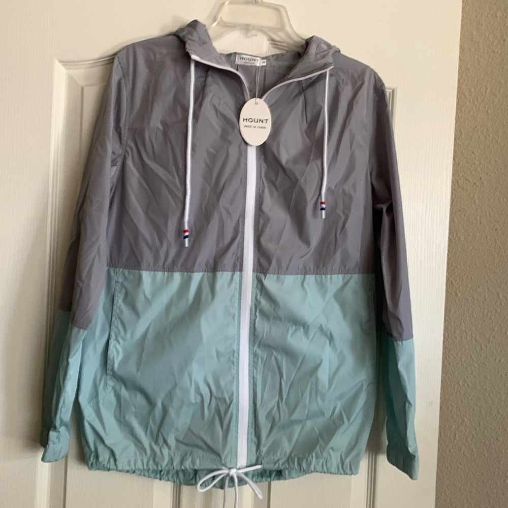 Ladies small windbreaker w/hood and storage bag.